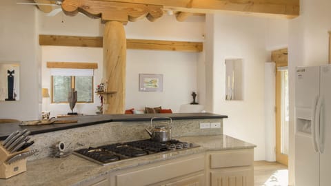 Jennaire range and island look to the nook, library and  door to upper patio