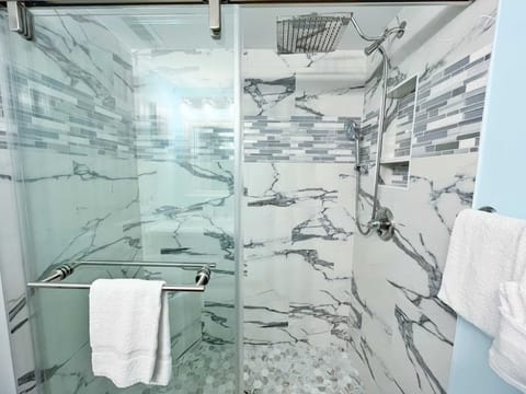 Newly remodeled bathroom with a beautifully tiled shower.