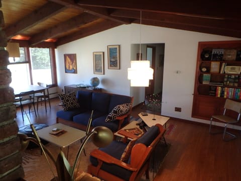 Cozy and authentically mod mid-century vibe in the living  room with open beam