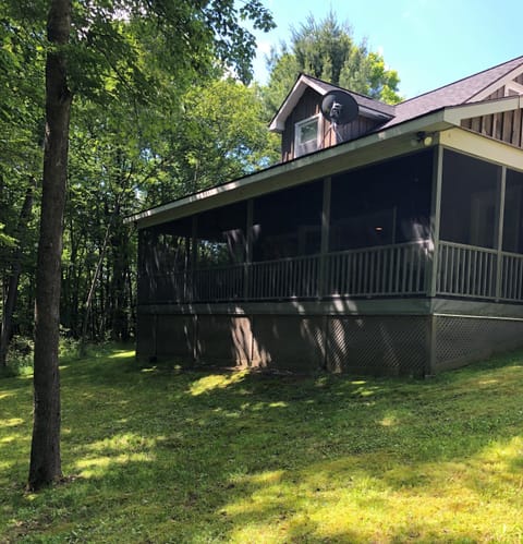 This is everyone's favorite. A cozy screened porch which faces the woods. 