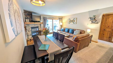 BC West J-2 living room with gas fireplace and balcony w/ propane BBQ grill