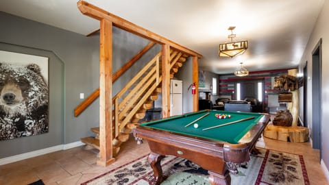 The first-floor entry is a popular gathering area. It is sometimes occupied by pool enthusiasts gathered around the pool table for a fun and competitive game. There is plenty of space for excited on-lookers to cheer for their favorite player!
