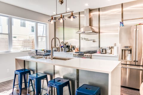 Fully stocked chef's kitchen with 8' island and 4 barstools