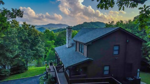 - Stunning mountain backdrop over cabin rooftop   - Perfectly nestled home surrounded by forest ridges   - Experience sunset views and peaceful mountain living