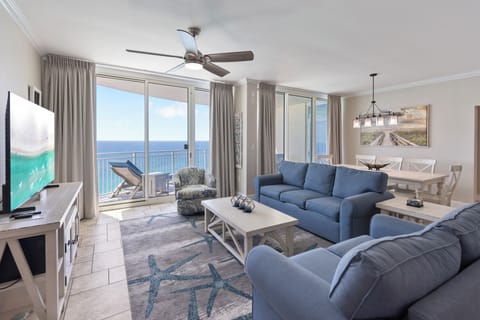 Unwind in your oceanfront living room where coastal blues meet comfort, and floor-to-ceiling windows frame endless sea views.