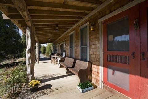 The front porch overlooks sunny gardens and woods, not another soul in sight!