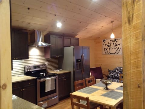 Full kitchen with dining room and sofa bed on the side