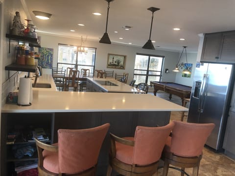 kitchen open to both pool table and FR and outside. bar seating for 6, table -12