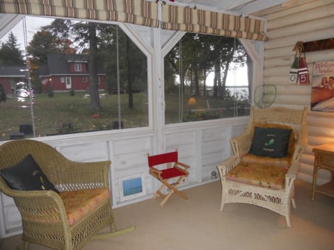 Screened porch with privacy curtains. Read a book or watch the birds. 