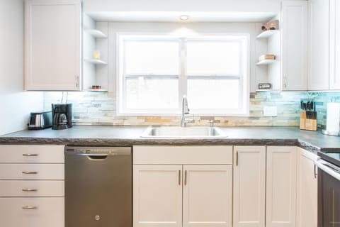 Kitchen with window facing beautiful back yard.