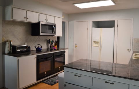 Kitchen with double ovens, microwave, toaster over, air fryer and instant pot.  