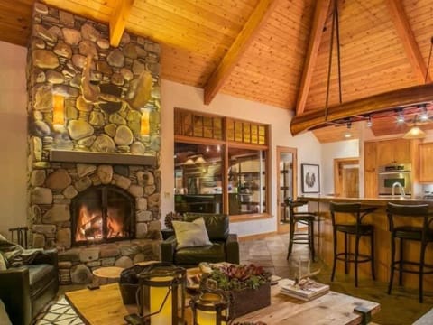 Great room at night with wood burning fireplace.