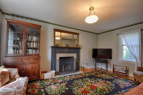 The sitting room combines historic atmosphere with modern comfort, including TV.