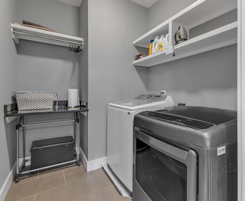 Laundry room with a spacious layout, allowing easy movement and organization. 