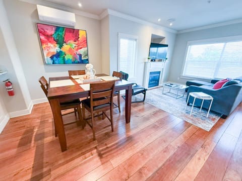 Bright, open, and artfully curated—this vibrant dining and living area features bold new canvas artwork and floods of natural light, offering the perfect backdrop for memorable meals and cozy nights