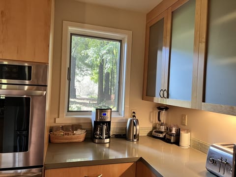 Coffee maker, toaster, electric kettle and coffee supplies.  