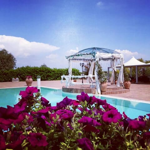Seasonal outdoor pool, open 6:00 AM to 6:00 PM, pool umbrellas