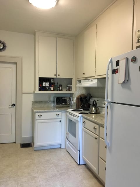 Period style, well stocked  kitchen, granite counters and dishwasher.