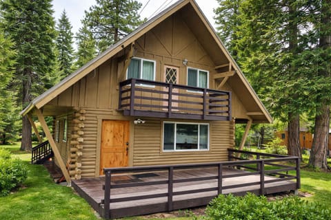 Charming cabin-style home with private decks, surrounded by tall pine trees, offering a peaceful and scenic mountain retreat.
