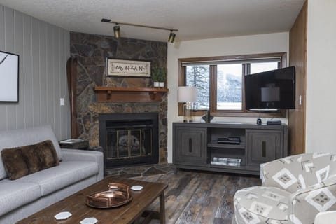 Updated living room with an electric fireplace.