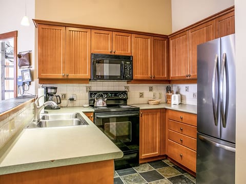 Kitchen - Kitchen with refrigerator, stove, microwave and sink.