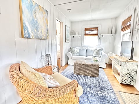 Charming living room with a slipcovered loveseat and chair.  