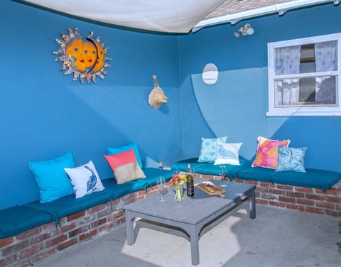 Relax on this inviting back patio with comfortable seating for six, ideal for meals, wine, or quiet moments. Whether reading, napping, or unwinding, this space offers a laid-back retreat.
