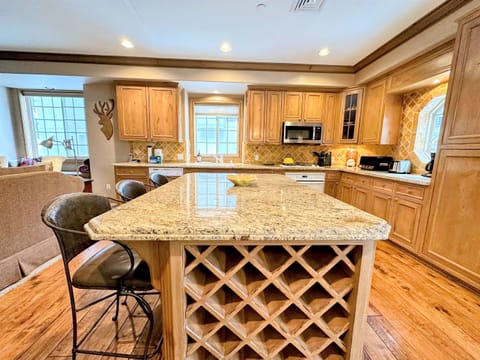Spacious kitchen offers a huge bar for apres ski snacks, breakfast, or hanging out.