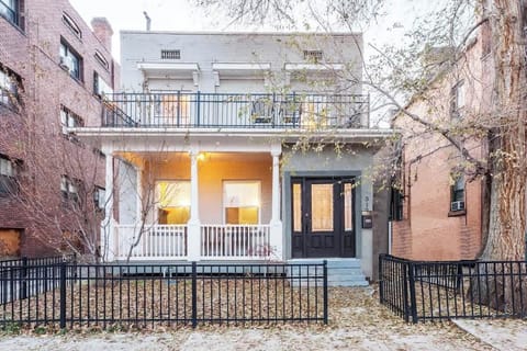 Charming exterior with a welcoming front porch and classic architecture, offering a warm first impression for your stay.