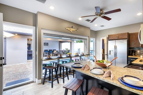 Indoor/Outdoor Bar – A unique kitchen pass-through window with seating for 10—perfect for serving drinks and snacks poolside.