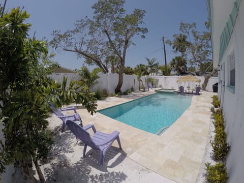 heated pool, sun shelf, built in hot tub, out door television grill