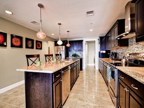 Generous kitchen with granite counters and stainless steel appliances.