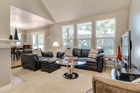Cozy family room with gas fireplace and leather sofa seating