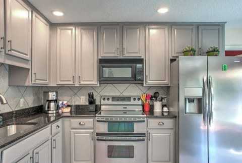 Kitchen is outfitted with an Electric Range w/ Double Ovens