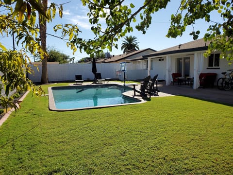 Heated pool with lush turf yard for sun, games, and relaxing afternoons.