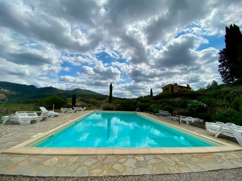 Collinella's large pool and paved gazebo with views of the landscape