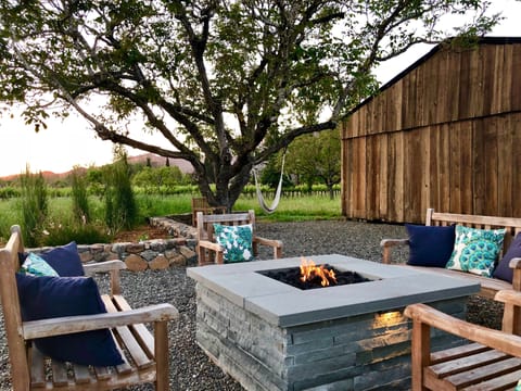 Sunset evenings in comfort at fire pit with view of barn & neighboring vineyards