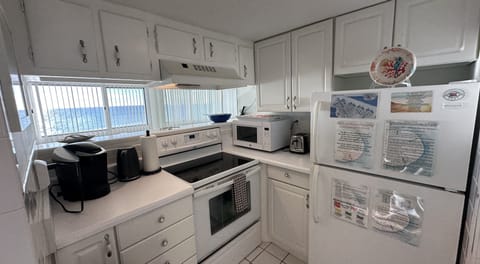 The kitchen is equipped with a Keurig, tea kettle, stove, microwave & toaster