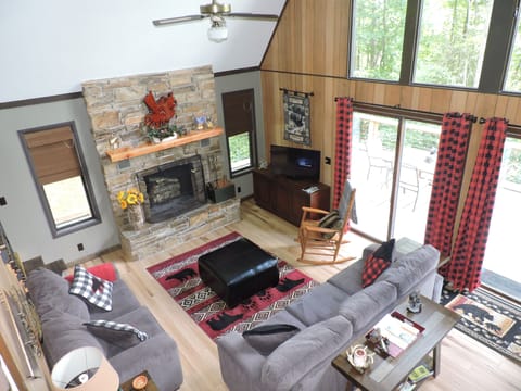 Great room w/wood burning fireplace, a 42" TV, sofa, loveseat & rocking chair.