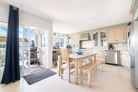 The kitchen opens out to the dining area, and front deck, for easy cookouts, game nights, you name it!
                