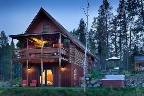 Chalet exterior with walkout master suite to hot tub & fire pit area.