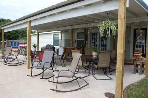 Back patio (plenty of seating, tables, fridge/freezer combo, grill, & fire pit)