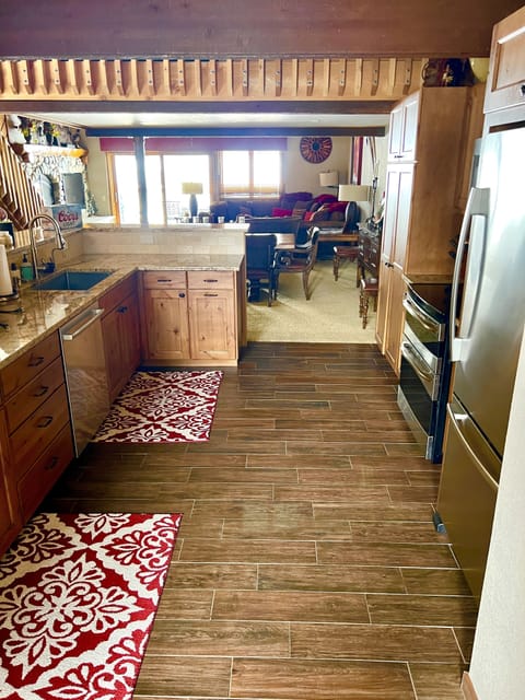 View from back of kitchen shows open floorplan into dining area & family room