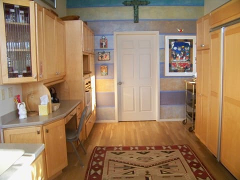 Large kitchen, large refrigerator and freezer, and pantries with dishes/bowls