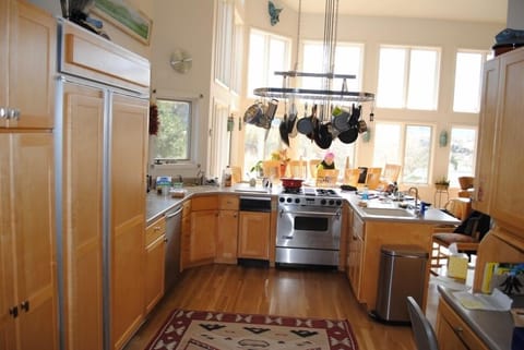 A chef's kitchen with built in refrigerator and two ovens
