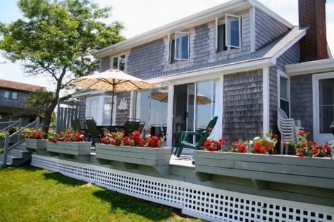 Back of house facing lawn and ocean