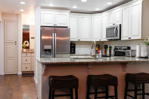 Beautifully renovated kitchen with granite counter tops and stainless appliances