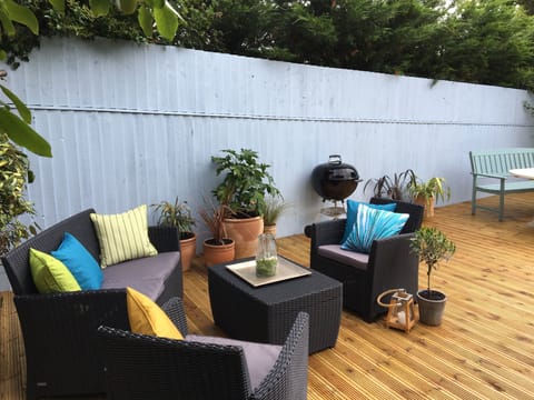 Sheltered decking with bbq, dining table for 12, and a lounging area