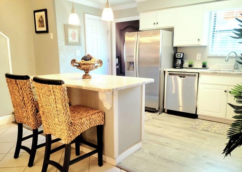 Kitchen with bar featuring extra setting.