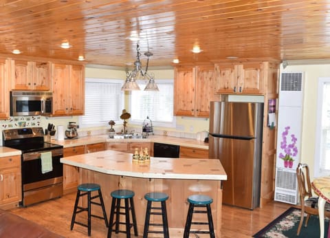 The modern rustic-style kitchen offers a spacious place to cook and enjoy a meal.